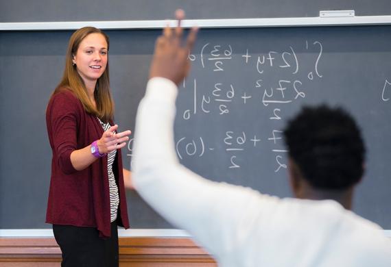 An image of a faculty member teaching in front of a class.